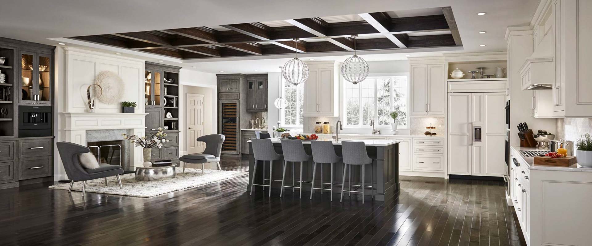 Open plan kitchen and living area with beautiful hard surface flooring and cabinetry.